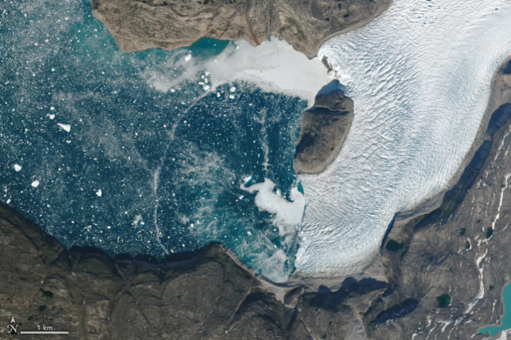 Ephemeral Arc Spans Greenland Fjord